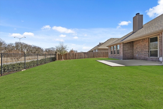 view of yard featuring a fenced backyard and a patio