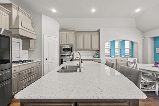 222 Oakcrest Dr, Justin, TX 76247 - kitchen with lofted ceiling, a sink, appliances with stainless steel finishes, a kitchen island with sink, and decorative backsplash