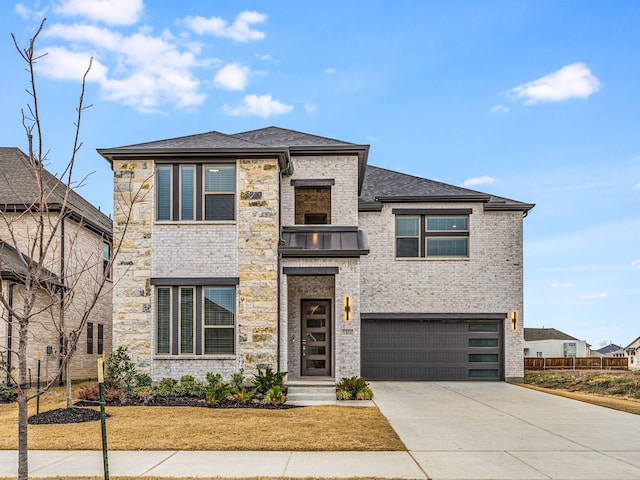 prairie-style home with a front yard, brick siding, a garage, and driveway