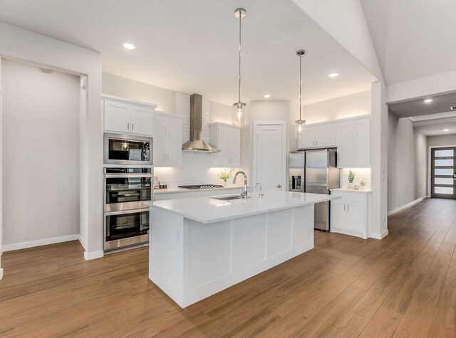 living area featuring high vaulted ceiling, a notable chandelier, visible vents, and wood finished floors