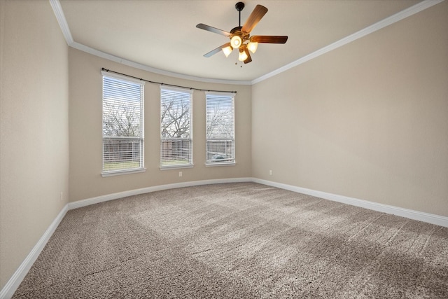 carpeted empty room with baseboards, crown molding, and a ceiling fan