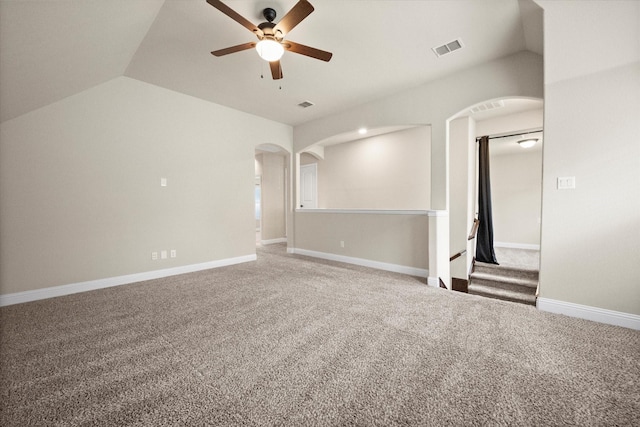 spare room featuring visible vents, arched walkways, ceiling fan, and vaulted ceiling