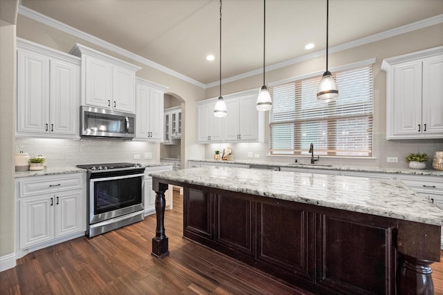 kitchen featuring dark wood-type flooring, white cabinets, appliances with stainless steel finishes, and a sink