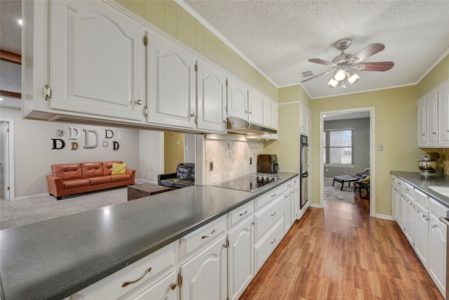 kitchen with double wall oven, ornamental molding, white cabinetry, a textured ceiling, and black electric cooktop