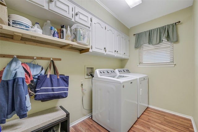 laundry room featuring light wood-type flooring, cabinet space, baseboards, and separate washer and dryer