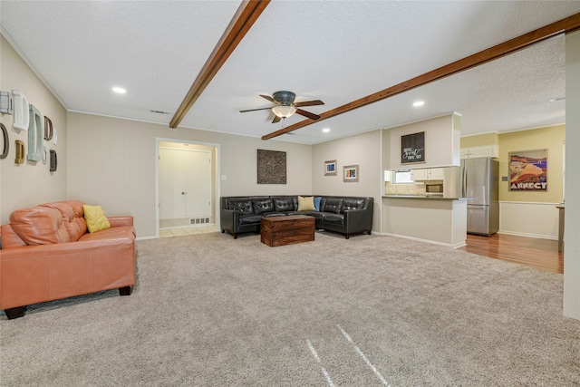 carpeted living area with recessed lighting, beamed ceiling, and a textured ceiling