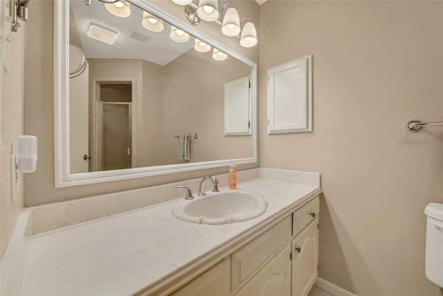 bathroom with visible vents, toilet, a shower with shower door, vanity, and baseboards