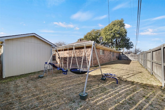 view of yard featuring a fenced backyard and a playground