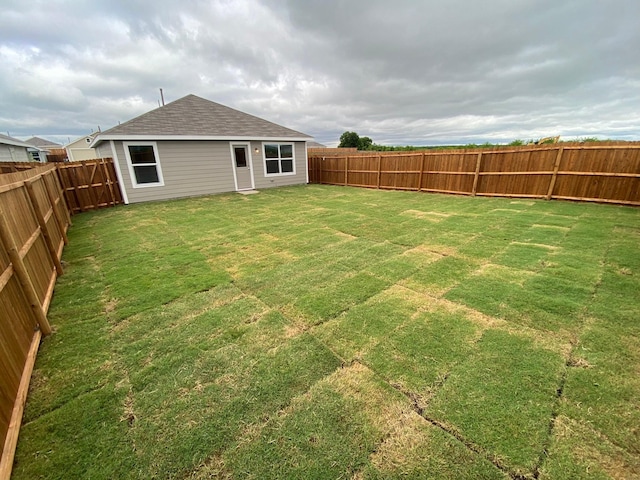 view of yard with a fenced backyard