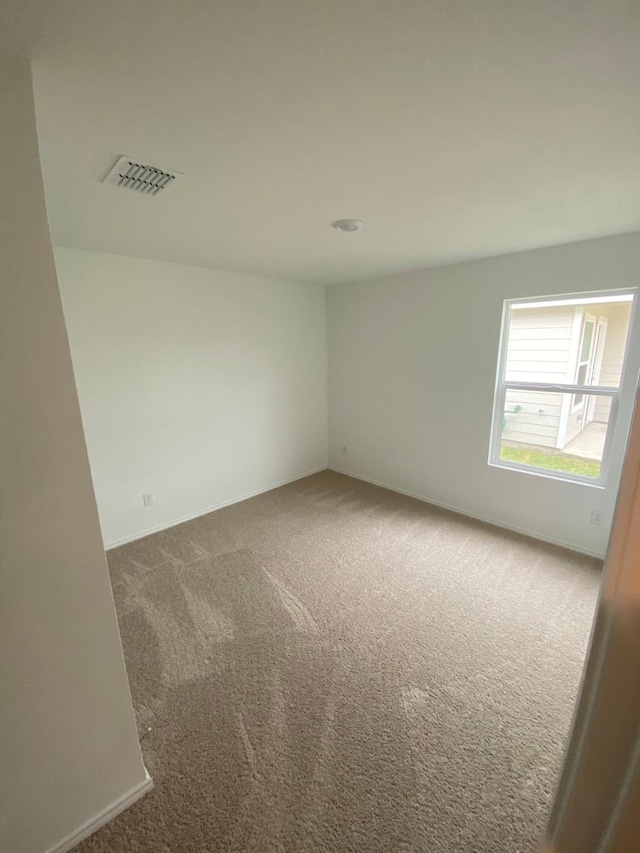 carpeted spare room with visible vents