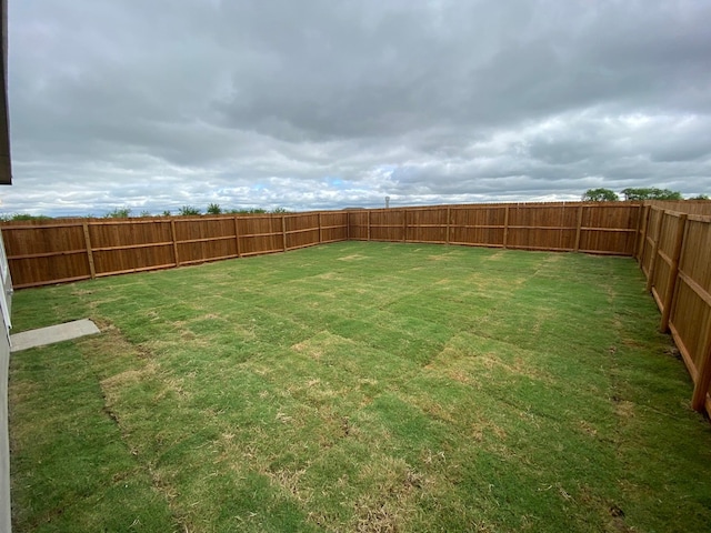 view of yard with a fenced backyard