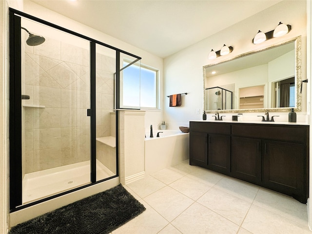 bathroom with a garden tub, tile patterned flooring, a sink, a shower stall, and double vanity