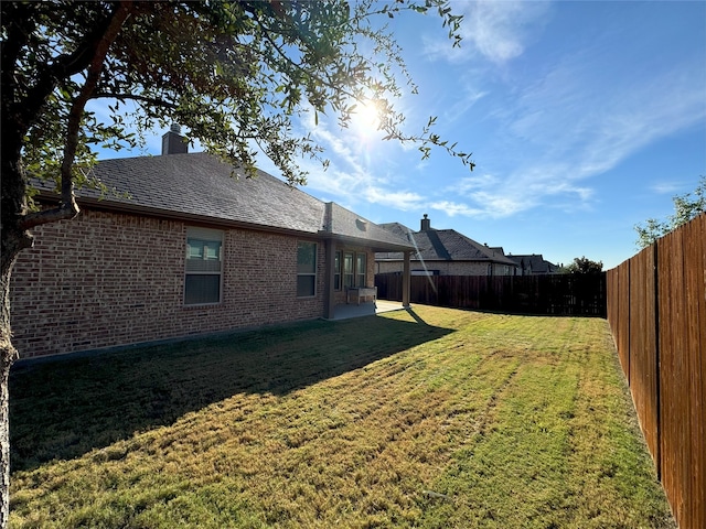 view of yard featuring a patio area and a fenced backyard