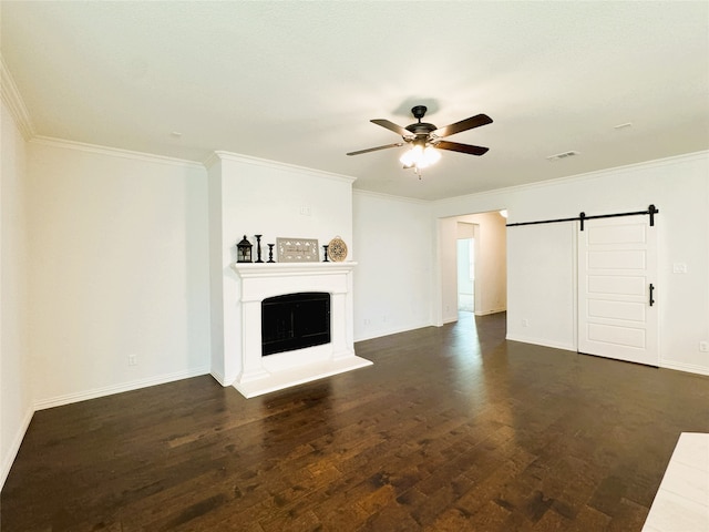 unfurnished living room featuring a barn door, visible vents, a fireplace with raised hearth, a ceiling fan, and dark wood-style floors