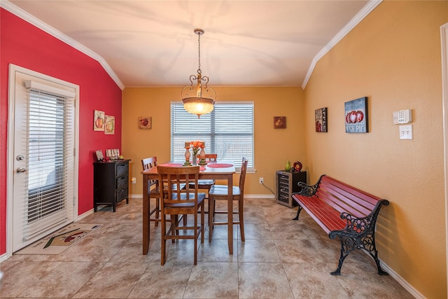 dining room featuring light tile patterned floors, baseboards, and crown molding