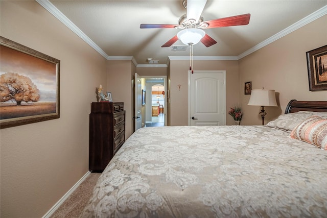 carpeted bedroom with baseboards, visible vents, a ceiling fan, and ornamental molding