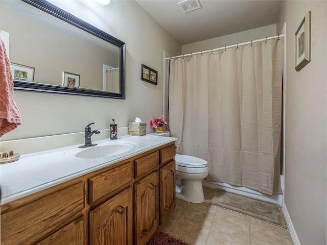 bathroom with toilet, vanity, visible vents, and tile patterned floors