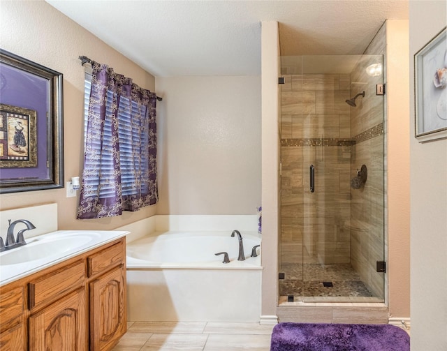 full bathroom with a stall shower, a garden tub, and vanity