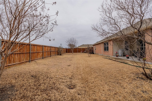 view of yard featuring a fenced backyard and a patio