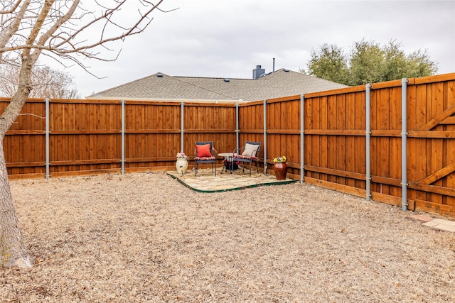 view of yard featuring a patio area and a fenced backyard