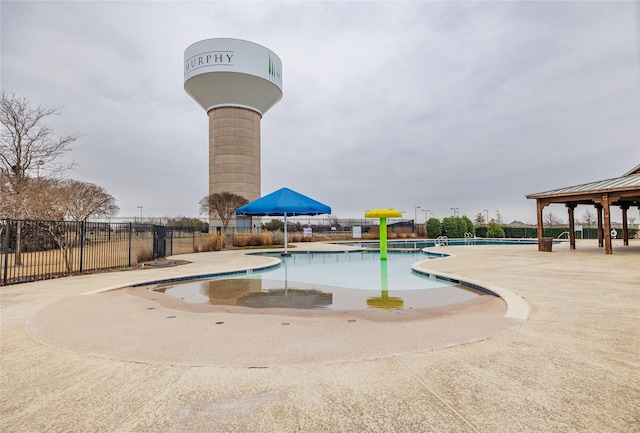 community pool featuring a gazebo, a patio area, and fence