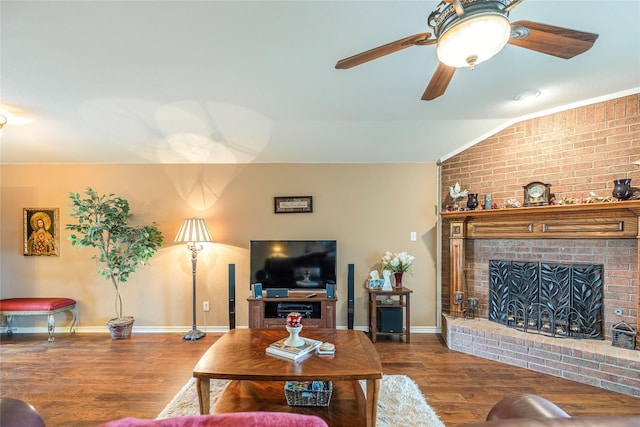 living room featuring vaulted ceiling, baseboards, and wood finished floors