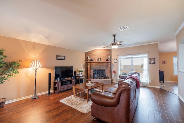 living area featuring dark wood-type flooring, visible vents, and a healthy amount of sunlight