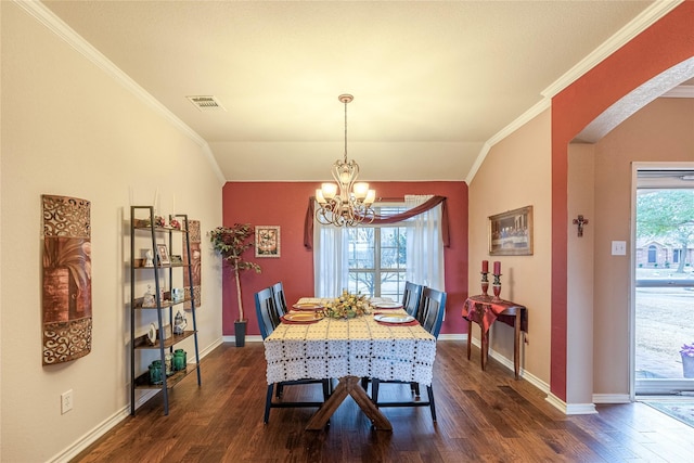 dining room featuring arched walkways, dark wood-type flooring, visible vents, a wealth of natural light, and an inviting chandelier