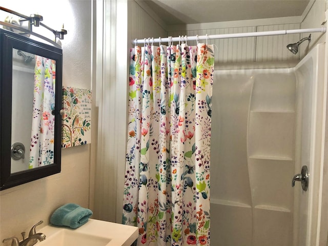 full bathroom with curtained shower and a sink