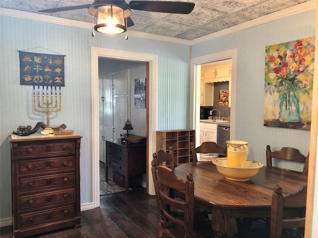 dining area featuring an ornate ceiling, ornamental molding, dark wood-style flooring, and a ceiling fan