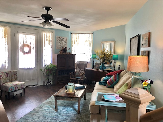 living area with ceiling fan and wood finished floors