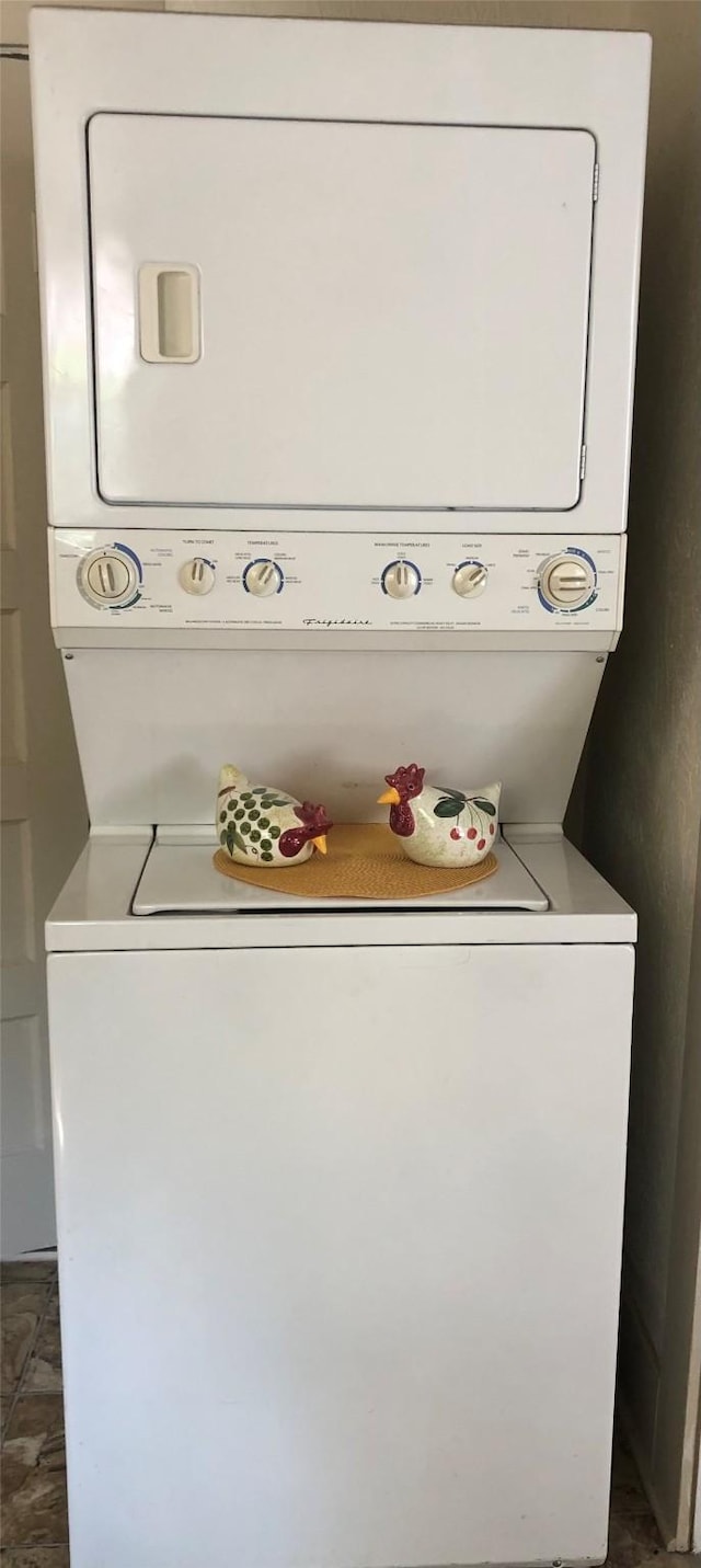 washroom with laundry area and stacked washing maching and dryer