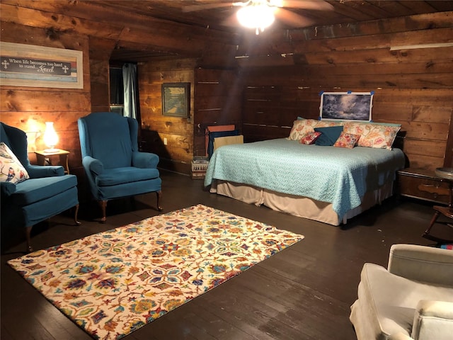 bedroom with wood walls and hardwood / wood-style flooring