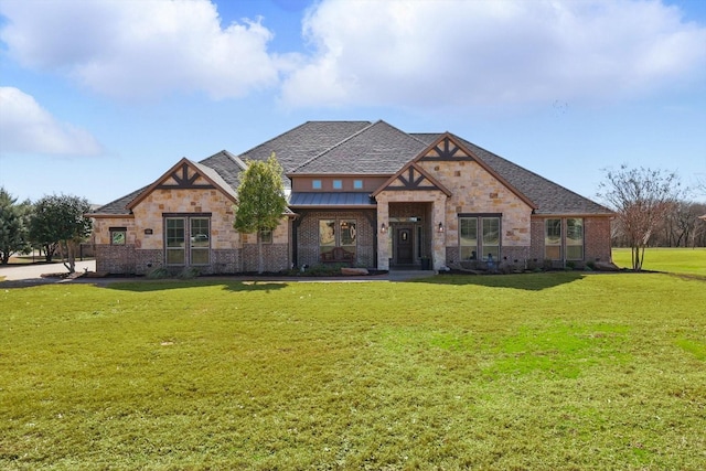 view of front facade with brick siding and a front lawn