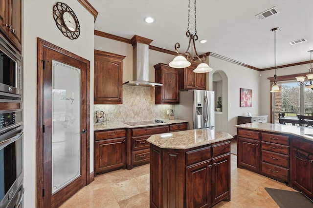 kitchen featuring stainless steel appliances, arched walkways, visible vents, and wall chimney range hood