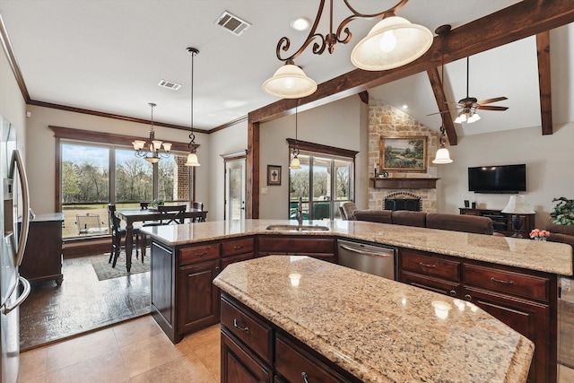 kitchen featuring appliances with stainless steel finishes, a sink, visible vents, and a center island