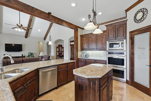 kitchen with arched walkways, lofted ceiling with beams, a sink, appliances with stainless steel finishes, and tasteful backsplash