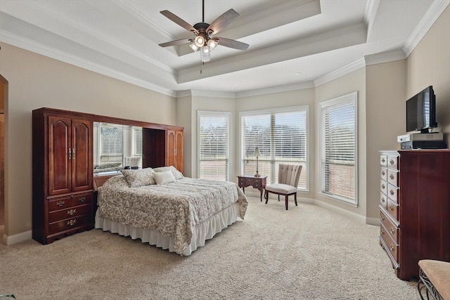 bedroom with light carpet, a tray ceiling, and crown molding