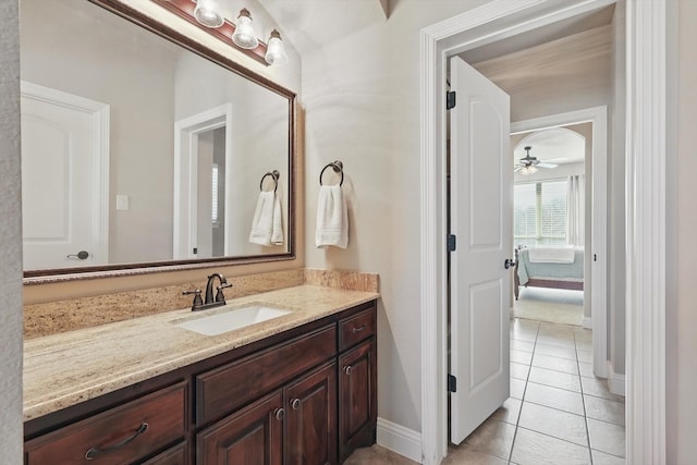 bathroom with baseboards, tile patterned floors, vanity, and a ceiling fan