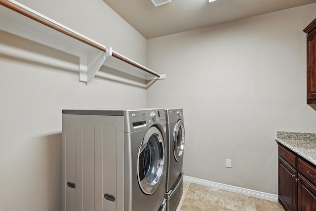 laundry room featuring cabinet space, visible vents, baseboards, and washer and dryer