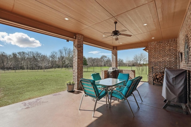 view of patio / terrace with ceiling fan, outdoor dining space, grilling area, and a fenced backyard