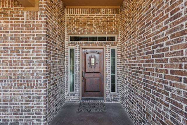 entrance to property with brick siding