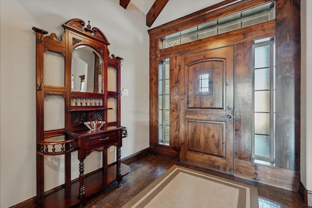 entrance foyer with lofted ceiling, dark wood finished floors, and baseboards