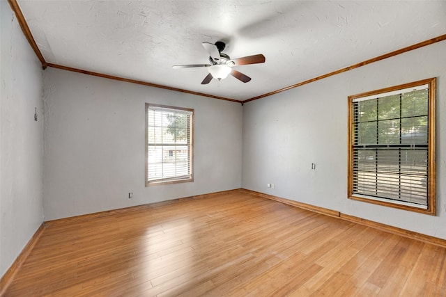 unfurnished room featuring a textured ceiling, ornamental molding, a ceiling fan, and light wood-style floors