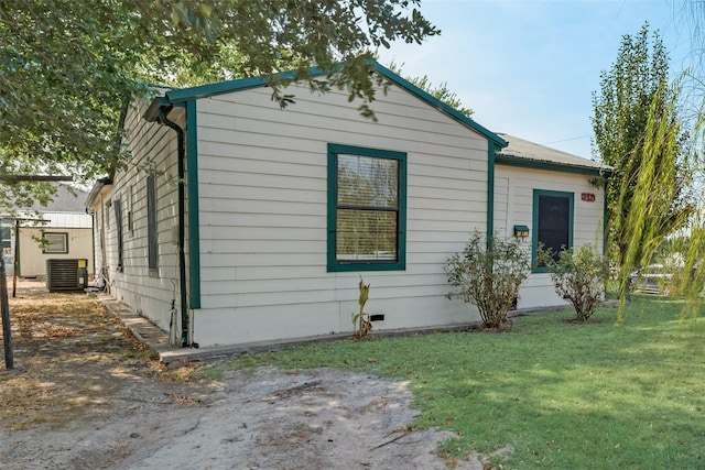 view of front of house with a front yard, crawl space, central AC, and metal roof