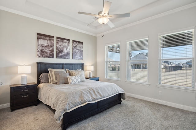 bedroom with baseboards, a tray ceiling, crown molding, and light colored carpet