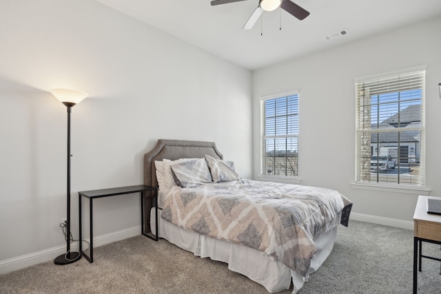 bedroom featuring a ceiling fan, baseboards, visible vents, and carpet flooring