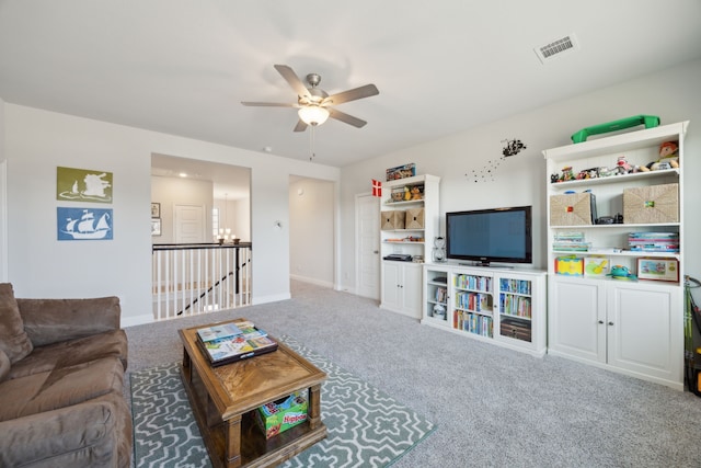 carpeted living area with a ceiling fan, visible vents, and baseboards