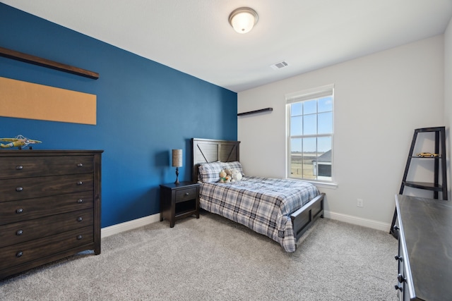 bedroom featuring light carpet, baseboards, and visible vents