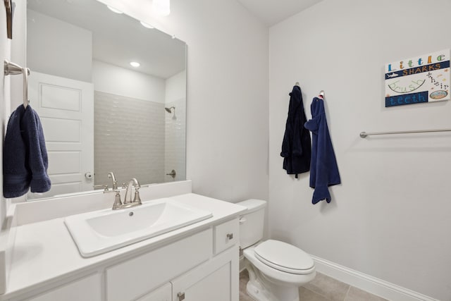 full bathroom featuring tile patterned flooring, toilet, vanity, baseboards, and walk in shower